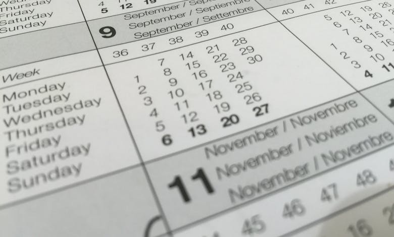Detailed close-up of a calendar displaying months in several languages.
