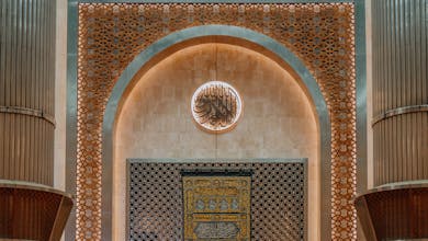 Worshippers gathered in the majestic Istiqlal Mosque, Jakarta, showcasing Islamic architecture.